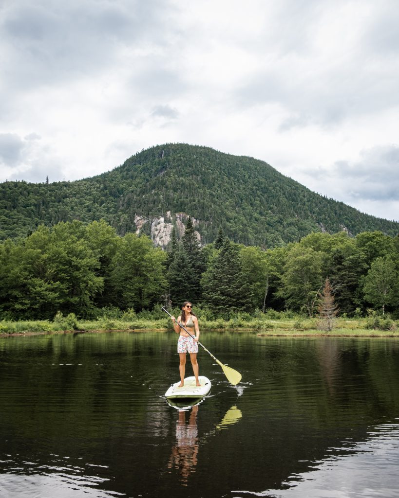 Paddle boarding on the lake at Noge, a glamping cabin in Quebec