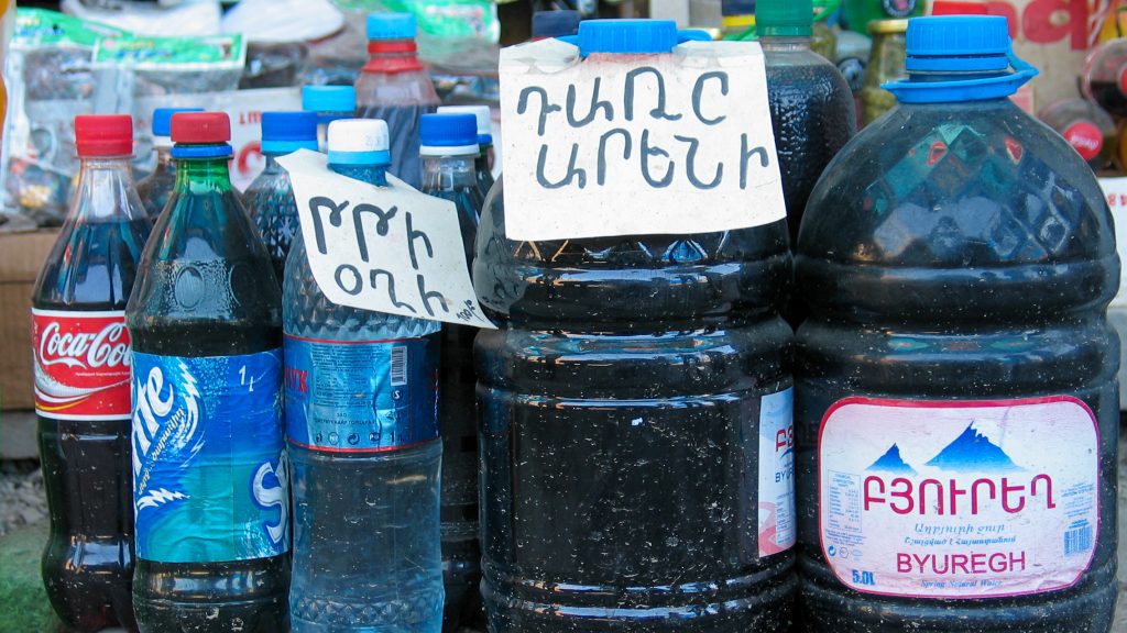 Moonshine wine and vodka sold on the side of the road in Armenia