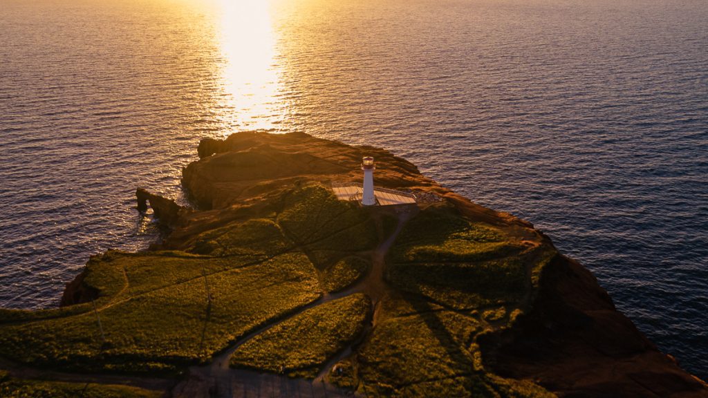Cap Alright lighthouse at sunset from the air in the Magdalen Islands