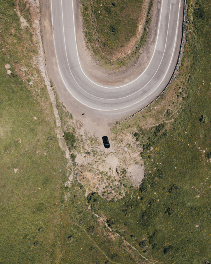 Rental car driving through the mountains of Armenia on a scenic road trip route.