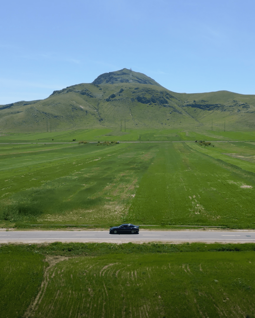 Open road in Armenia with mountain views in the distance.